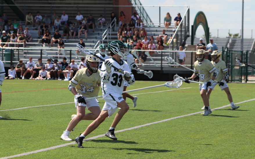 boys defending and running on field